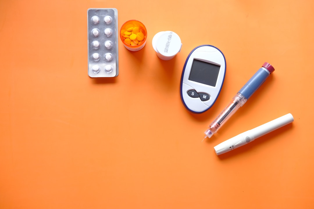 A close-up of a blood glucose test strip and monitor, representing the type of invasive testing that wearable sensors could potentially replace for early disease screening