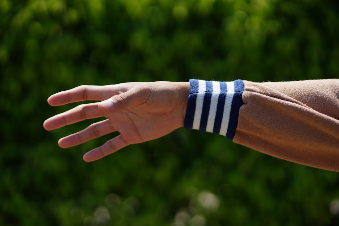 Close view of a wristband on an athlete's arm in daylight, showing where continuous strain tracking lives during training