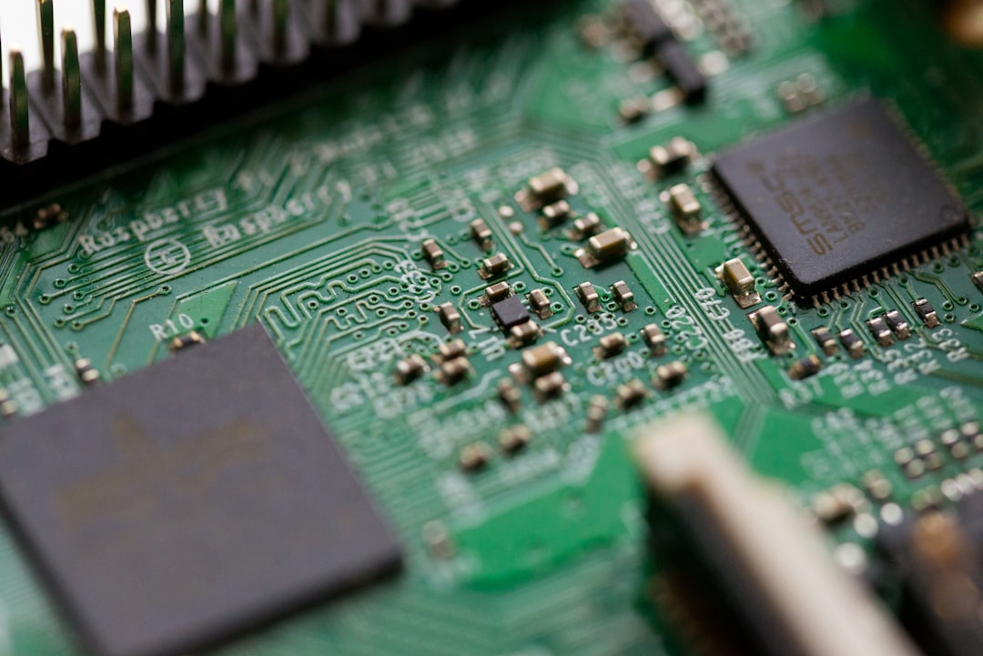 Tilt-shift view of green motherboard circuits showing power routing constraints in compact electronics