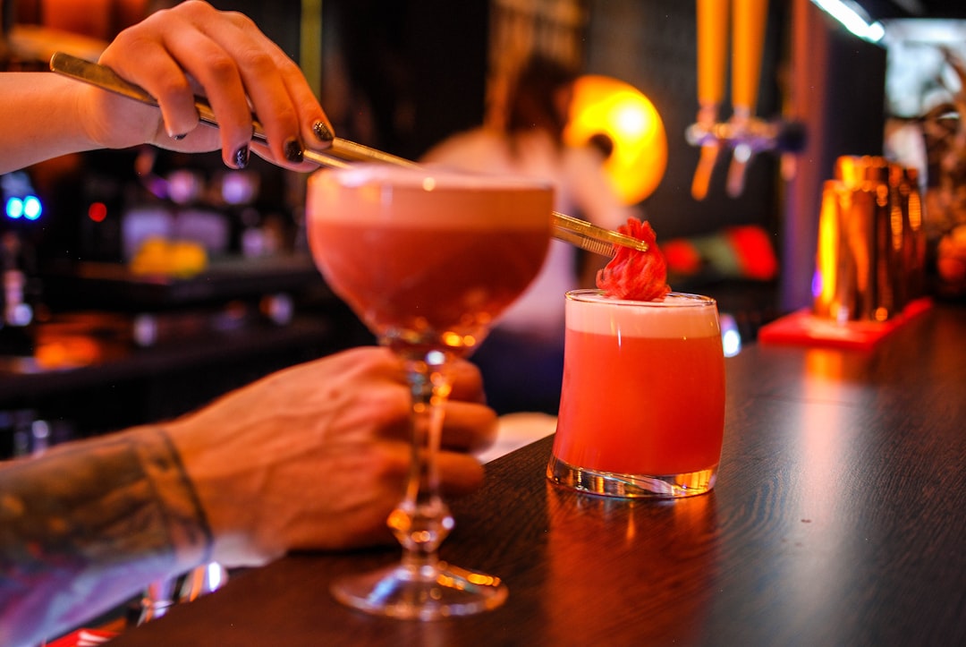 A glass of wine and alcoholic drinks on a bar table, representing the common context of drinking before sleep