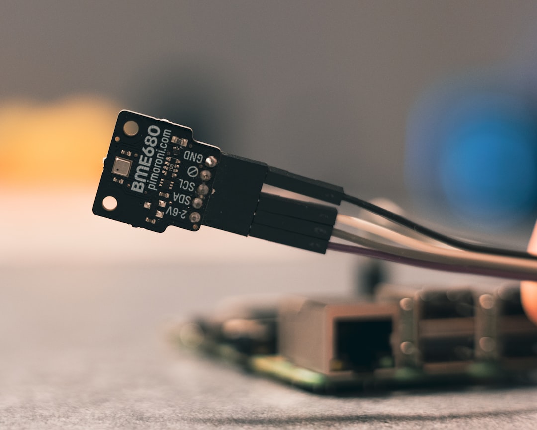 A closeup of a MEMS accelerometer chip on a circuit board -- the tiny silicon device that provides the reference signal for adaptive motion filtering in wearable devices