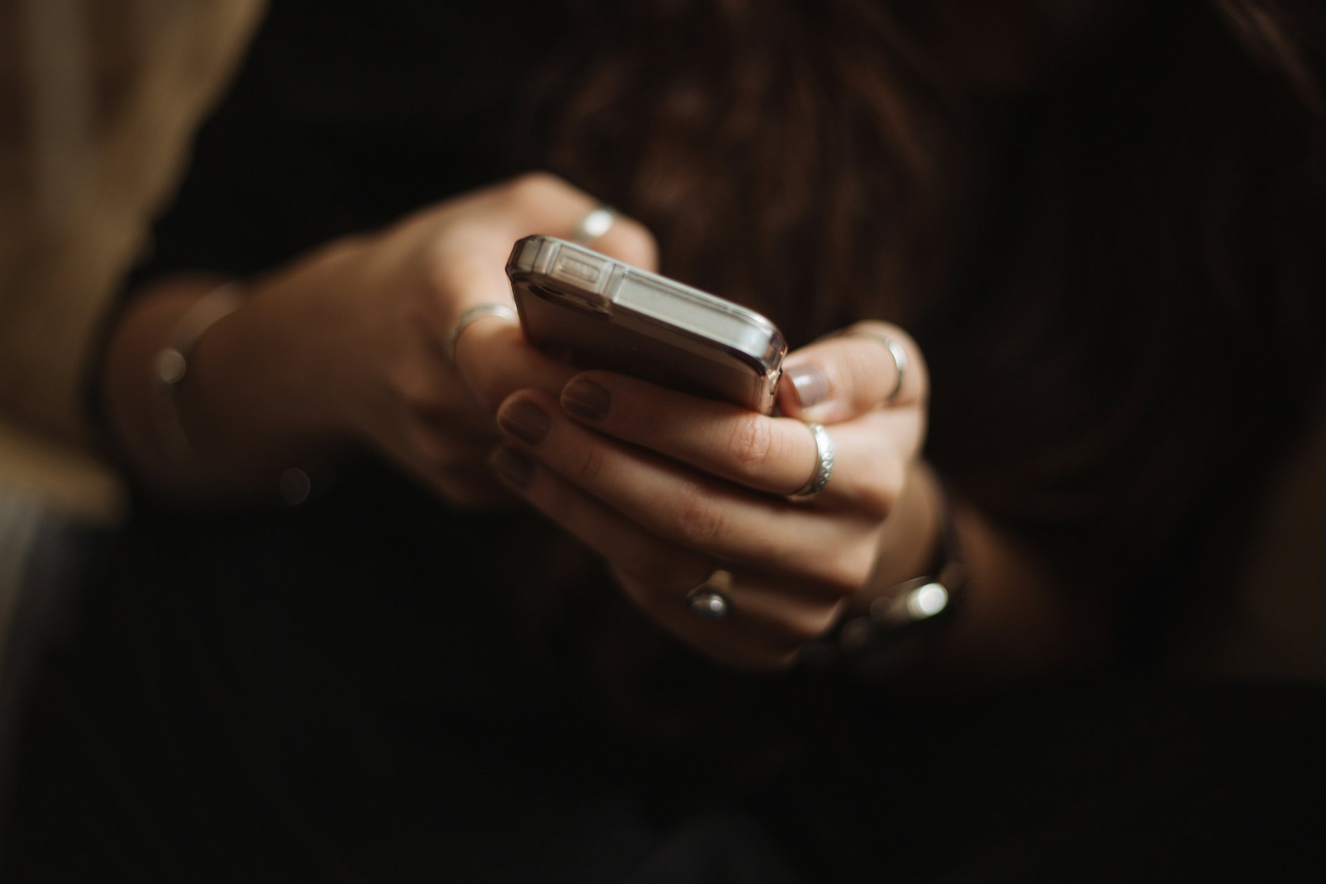 A person holding a phone with a health dashboard visible, looking stressed rather than informed