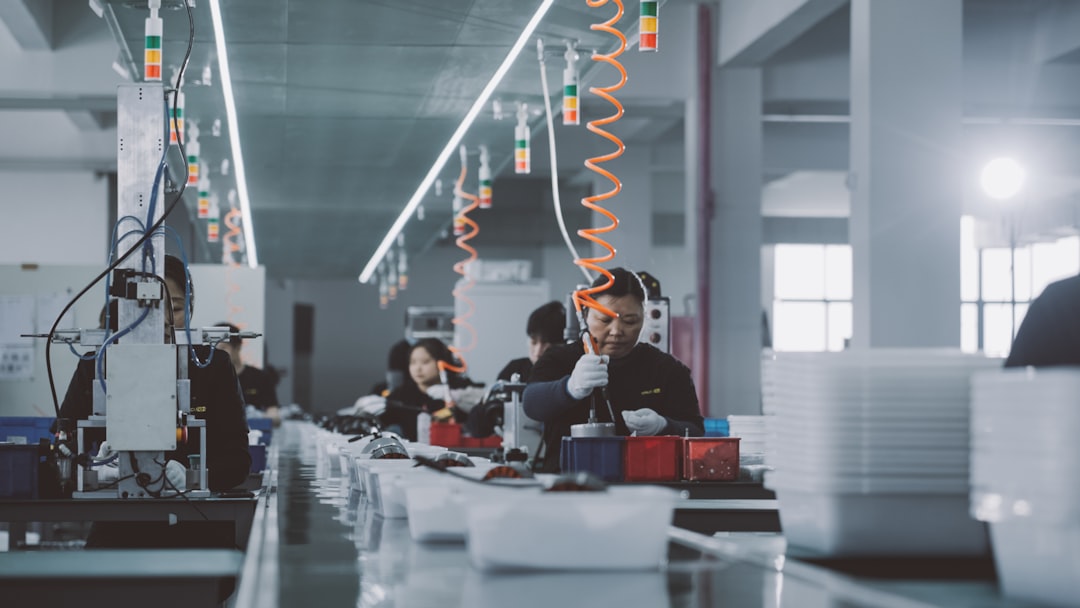 Workers on an electronics assembly line, illustrating how few factories build most small wearables