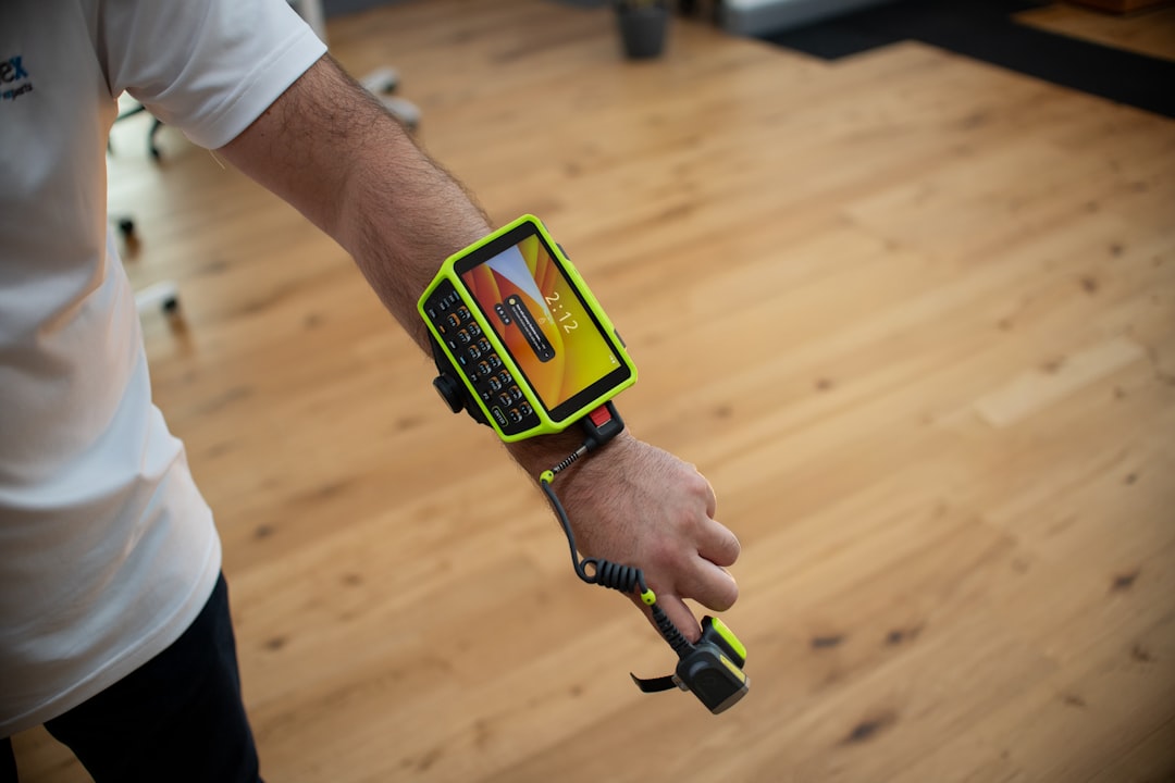 Close view of a wrist wearable on an arm at a desk, representing early testing of readiness and strain calculations