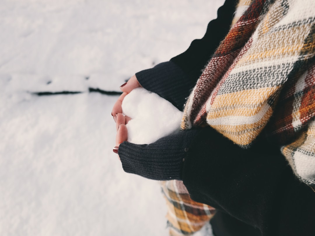 Frost-covered hands in cold weather. The same vasoconstriction that makes your fingers cold also breaks your smart ring optical sensor.