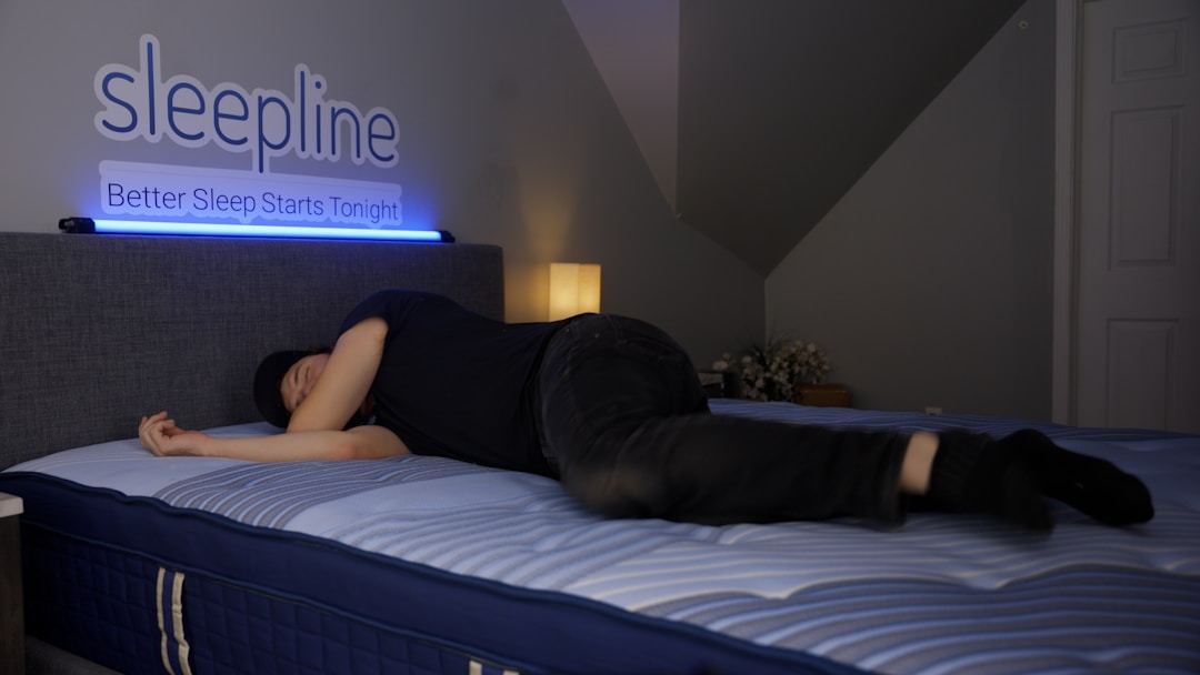 A person sleeping on their side with a smart ring on their finger, illustrating how body position compresses the finger against a pillow or mattress