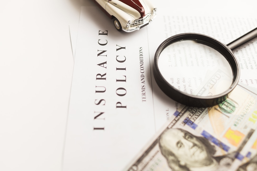 A stack of insurance paperwork and documents on a desk, representing the fine print in wearable data sharing agreements