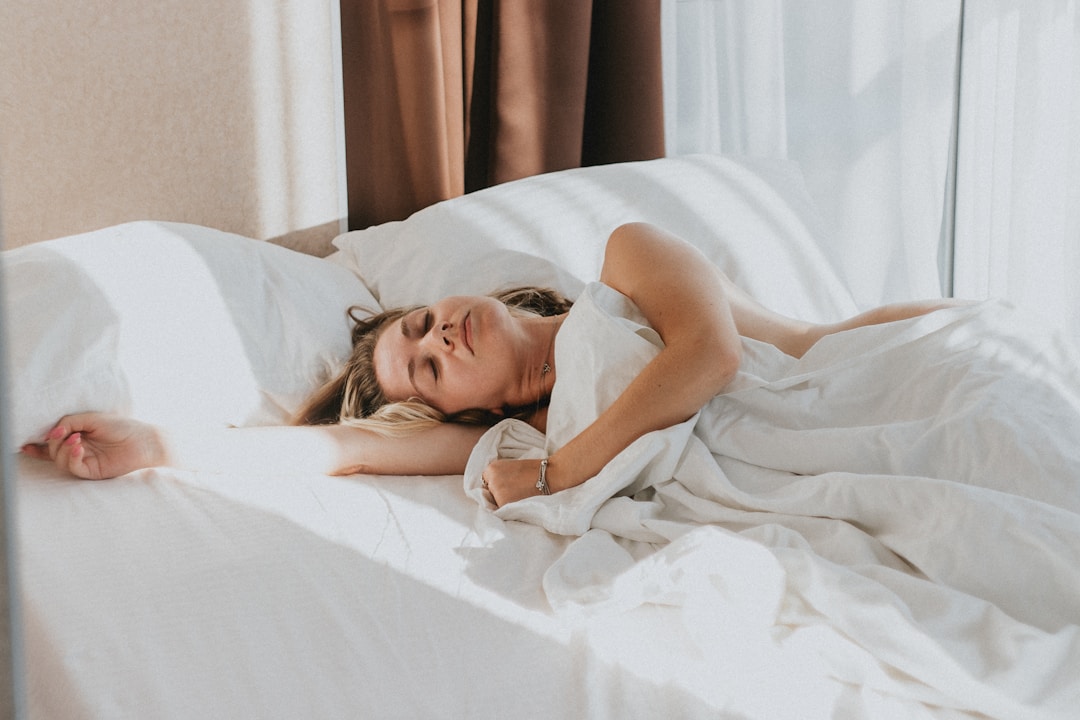 A dark bedroom with a person lying awake in bed, the kind of scene orthosomnia creates for people who obsess over sleep tracker data